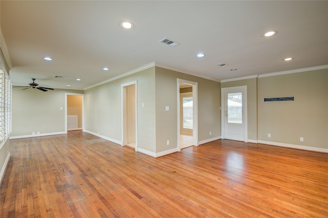 empty room with ceiling fan, crown molding, and light hardwood / wood-style flooring