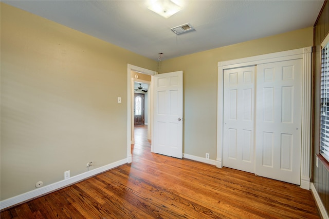 unfurnished bedroom with light hardwood / wood-style flooring and a closet