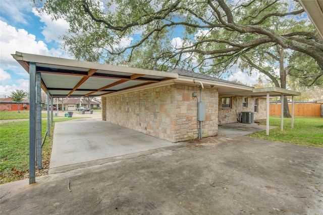 exterior space featuring a yard and a carport