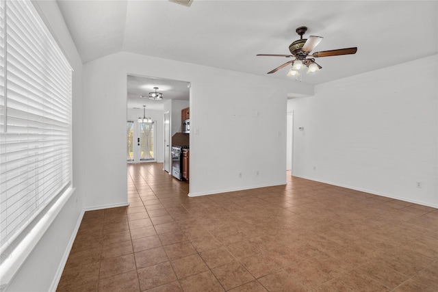 tiled spare room featuring lofted ceiling and ceiling fan