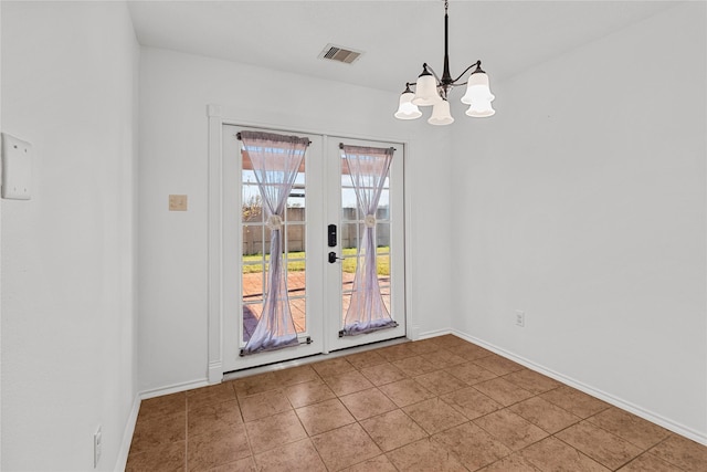 interior space featuring french doors and a chandelier