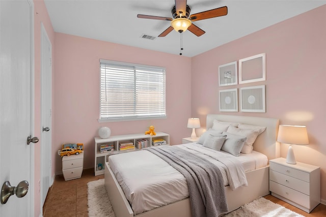 tiled bedroom featuring ceiling fan