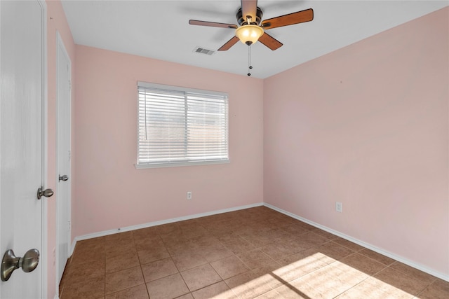 empty room with light tile patterned flooring and ceiling fan