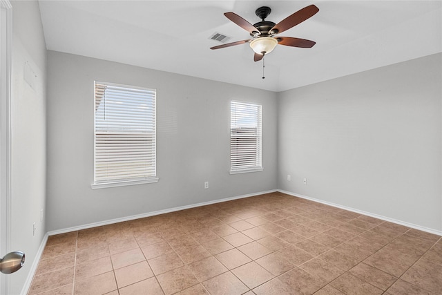 tiled empty room featuring ceiling fan