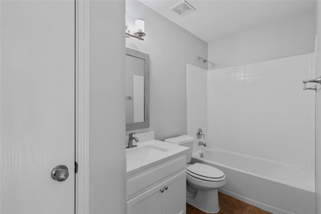 full bathroom with toilet, a textured ceiling, bathing tub / shower combination, and vanity