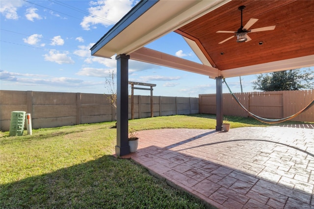 view of yard featuring ceiling fan and a patio