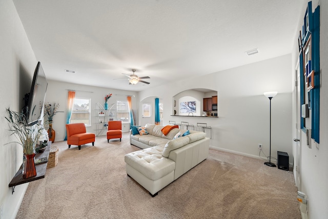 living room featuring ceiling fan and light carpet