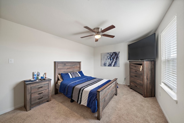 bedroom with ceiling fan and light colored carpet