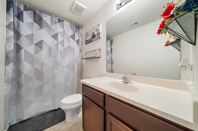 bathroom featuring a shower with shower curtain, vanity, tile patterned floors, and toilet