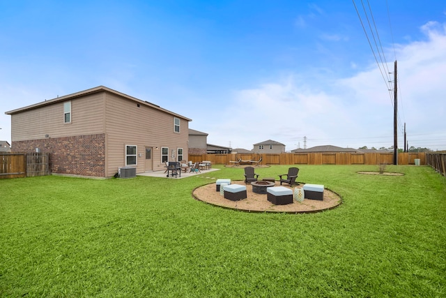 view of yard with a patio, cooling unit, and a fire pit