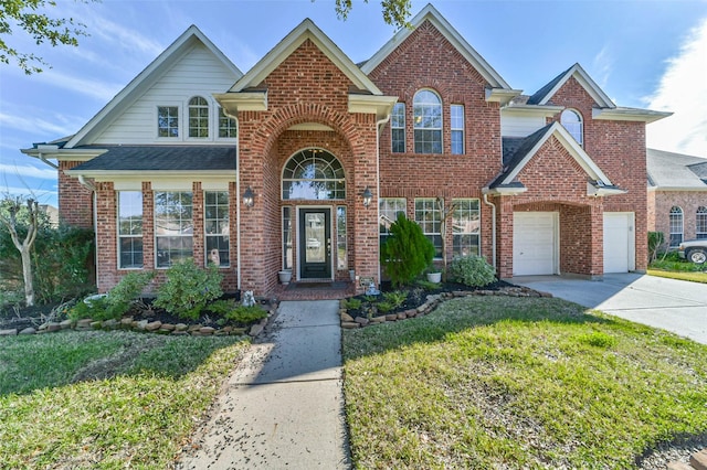 view of front property featuring a front lawn and a garage