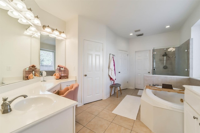 bathroom with shower with separate bathtub, vanity, and tile patterned floors