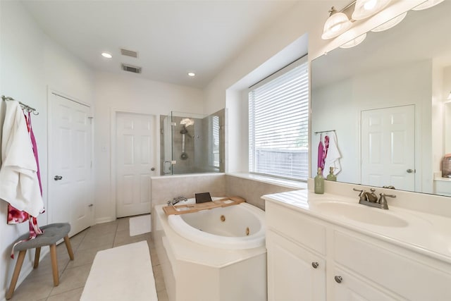 bathroom featuring tile patterned floors, independent shower and bath, and vanity