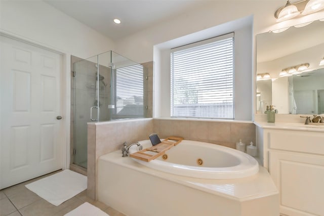 bathroom featuring shower with separate bathtub, tile patterned floors, and vanity