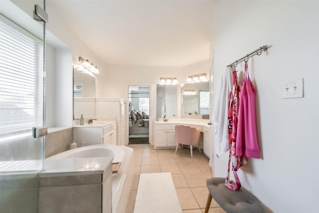 bathroom featuring a bath, vanity, and tile patterned floors