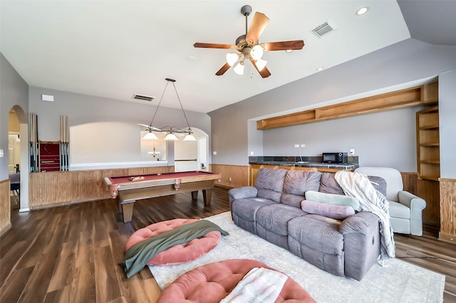 living room with pool table, ceiling fan, wood walls, and dark hardwood / wood-style floors