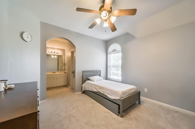 carpeted bedroom with sink, ensuite bathroom, and ceiling fan