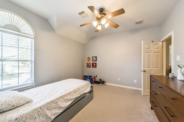 carpeted bedroom with vaulted ceiling and ceiling fan