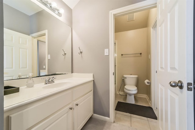 bathroom featuring vanity, tile patterned floors, and toilet