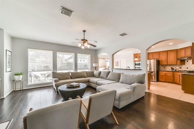 living room featuring hardwood / wood-style flooring and ceiling fan