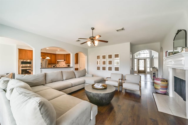 living room featuring dark hardwood / wood-style flooring and ceiling fan