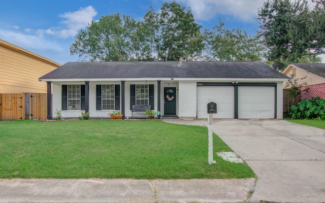 single story home with covered porch, a garage, and a front yard