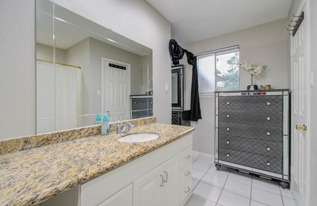 bathroom featuring tile patterned floors and vanity