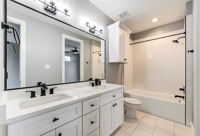 full bathroom featuring toilet, tiled shower / bath combo, vanity, and ceiling fan