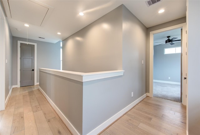 hallway with light hardwood / wood-style floors