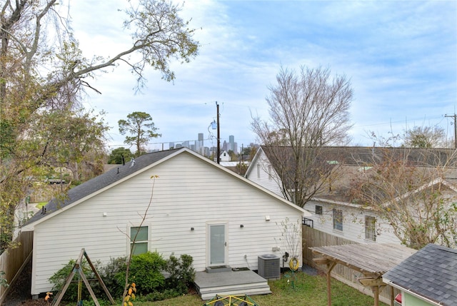 back of house featuring central AC