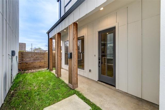 view of property exterior featuring a patio and a lawn