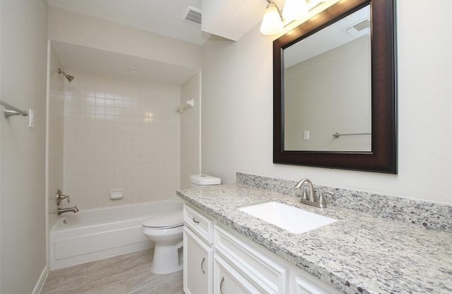 full bathroom featuring toilet, vanity, and tiled shower / bath combo