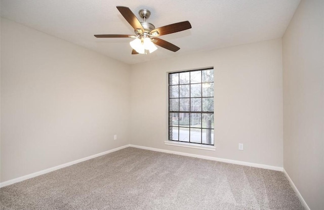 unfurnished room featuring carpet, ceiling fan, and a wealth of natural light