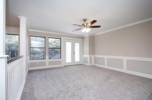 empty room with ornamental molding, ceiling fan, and french doors