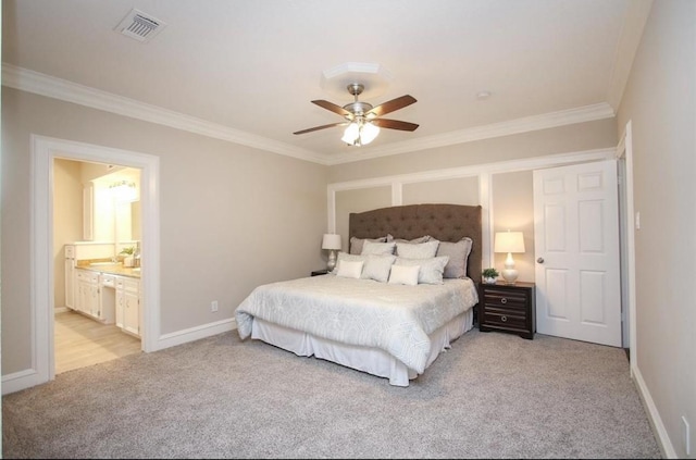 carpeted bedroom featuring ensuite bath, ceiling fan, and crown molding