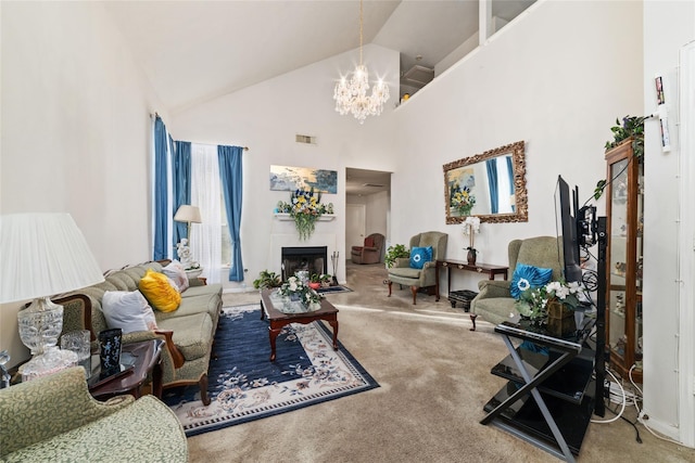 living room featuring high vaulted ceiling, an inviting chandelier, and carpet floors