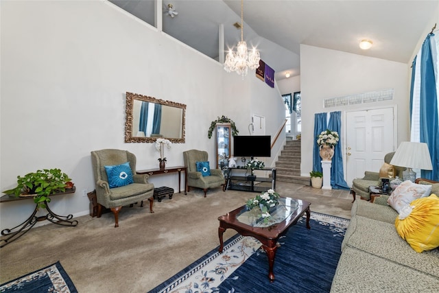 carpeted living room with high vaulted ceiling and a chandelier