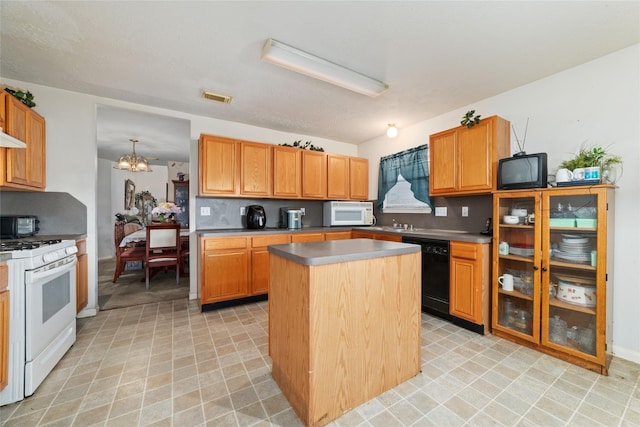 kitchen with white appliances, an inviting chandelier, decorative backsplash, and a center island