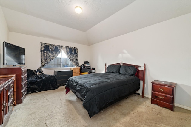 bedroom featuring vaulted ceiling and light colored carpet