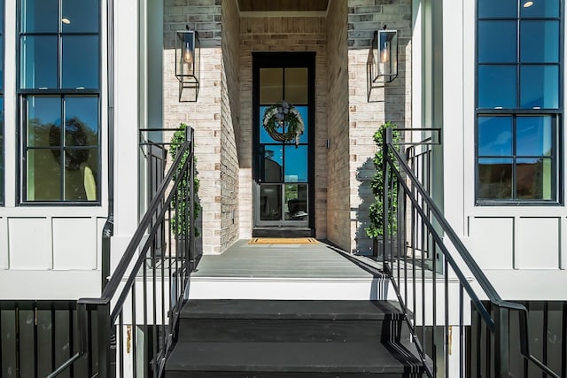 property entrance with stone siding and brick siding