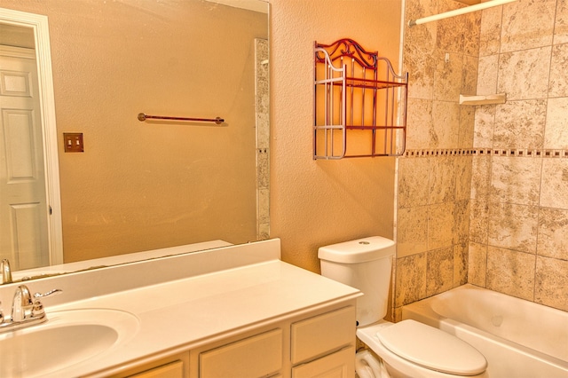 full bathroom featuring toilet, vanity, and tiled shower / bath