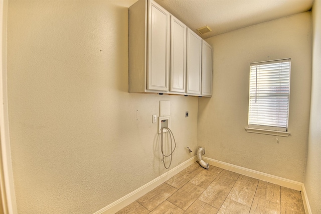 clothes washing area with gas dryer hookup, electric dryer hookup, hookup for a washing machine, and cabinets