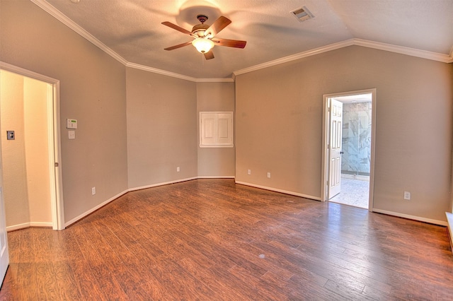 empty room with dark hardwood / wood-style flooring, ceiling fan, vaulted ceiling, and ornamental molding