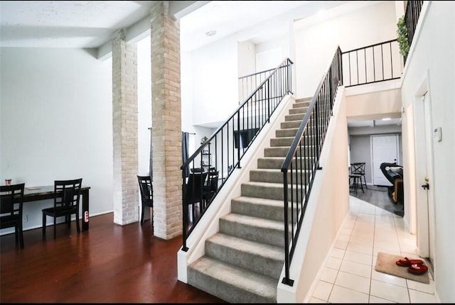 stairs featuring vaulted ceiling and hardwood / wood-style floors