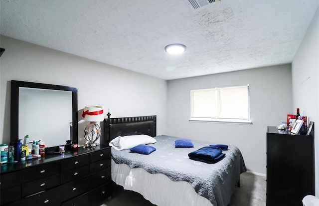 carpeted bedroom featuring a textured ceiling