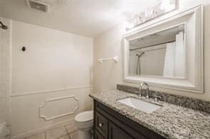 full bathroom with vanity, toilet, tile patterned floors, and shower / bathing tub combination