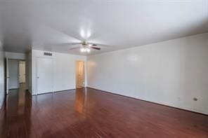 spare room featuring ceiling fan and dark hardwood / wood-style floors