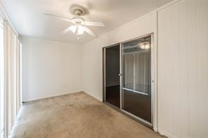 spare room with light carpet and ceiling fan