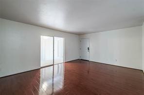 empty room with dark wood-type flooring