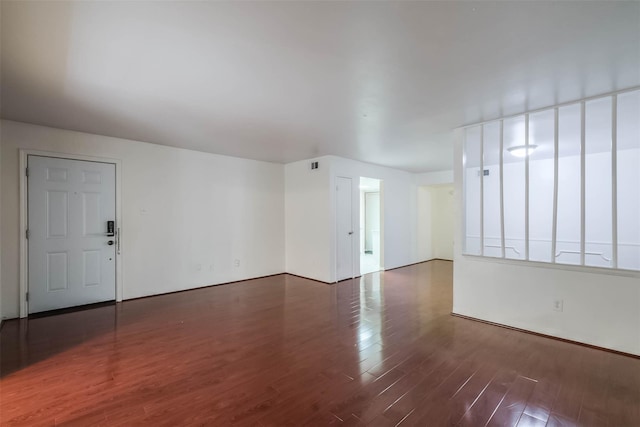 empty room with dark wood-type flooring